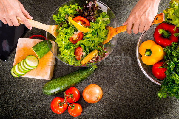 Healthy Woman makes fresh vegetable salad with olive oil, tomato Stock photo © snowing