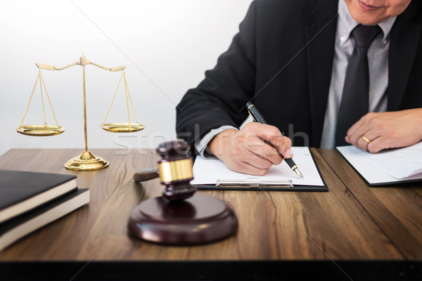 lawyer hand writes the document in court (justice, law) with sou Stock photo © snowing