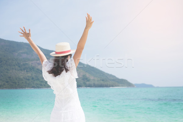 Stock photo: a beautiful carefree Woman relaxing at the beach enjoying her su