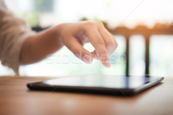 Close up of mans hands using tablet on counter. Stock photo © snowing