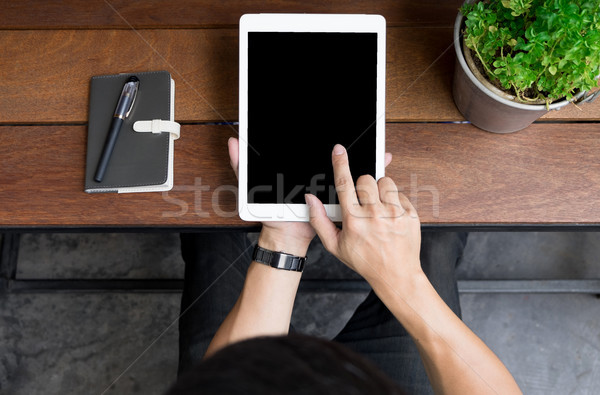 Close up of mans hands using tablet on counter, Image taken from Stock photo © snowing