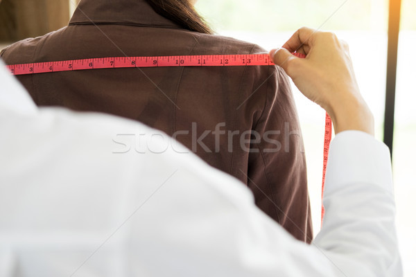 Fashion designer measuring on body part of women for a tailor ma Stock photo © snowing