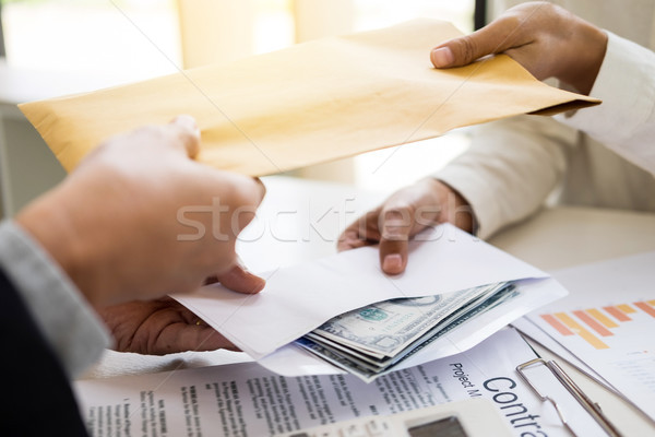 Corrupted businessman, or politician bribe in the form of hundre Stock photo © snowing