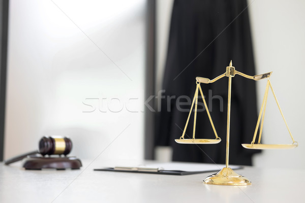 Scales of justice and gavel Judge hammer on brown wooden desk wi Stock photo © snowing