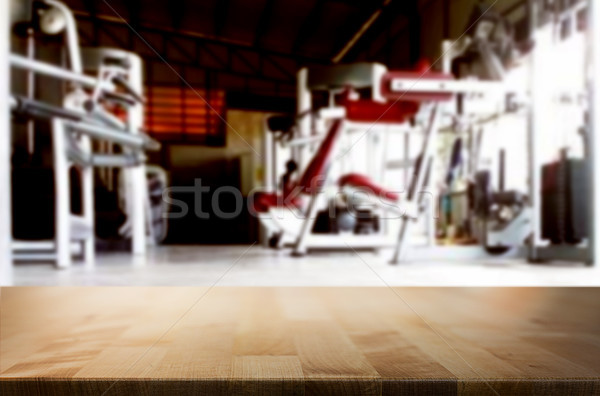 Wooden table on blurred background of fitness gym interior of mo Stock photo © snowing