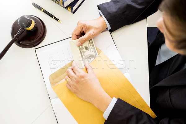 Lawyer being offered receiving money as bribe from client at des Stock photo © snowing
