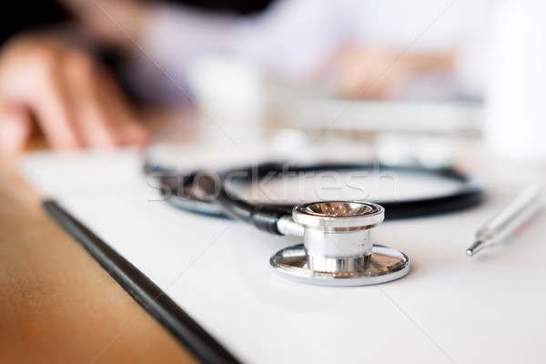 View of stethoscope and equipment on foreground table with docto Stock photo © snowing