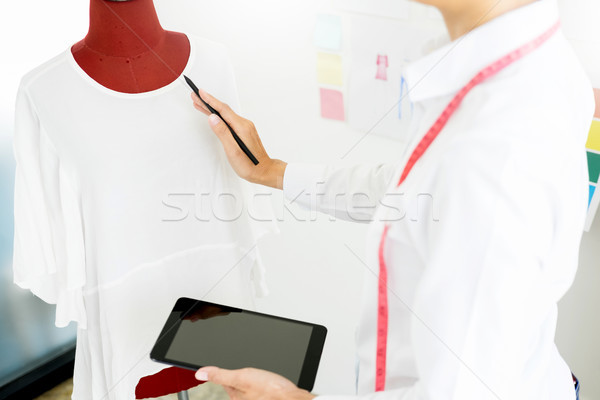 Stylish fashion designer working with measure red dummy as sketc Stock photo © snowing