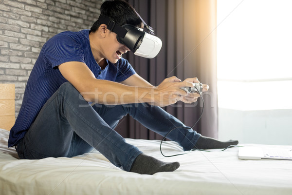 The VR headset design is generic and no logos, Man wearing virtu Stock photo © snowing