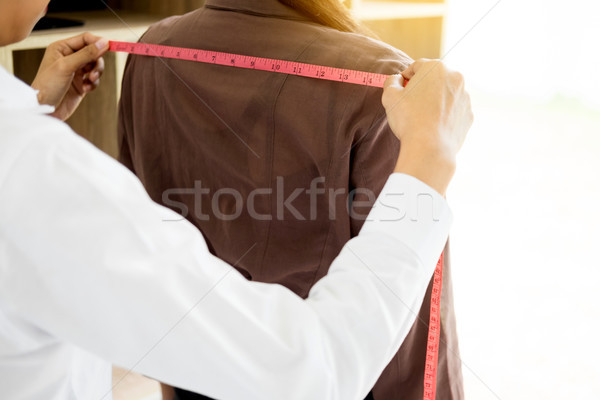 Fashion designer measuring on body part of women for a tailor ma Stock photo © snowing