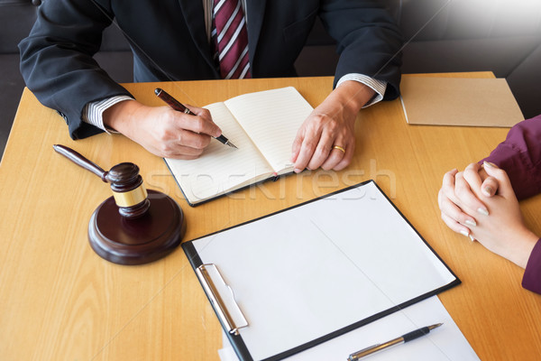 business people and lawyers discussing contract papers sitting a Stock photo © snowing