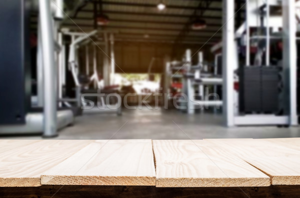 Wooden table on blurred background of fitness gym interior of mo Stock photo © snowing