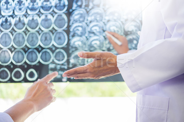 Two doctors analyzing a scan or x-ray film or  explains a CT sca Stock photo © snowing