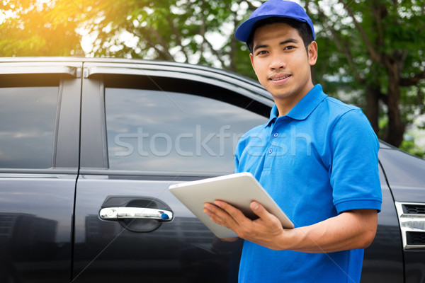 Delivery man checking document list on clipboard outdoor and Car Stock photo © snowing