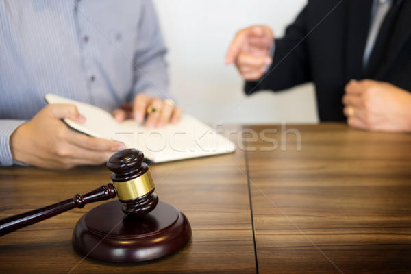 Stock photo: Gavel Justice hammer on wooden table with judge and client shaki