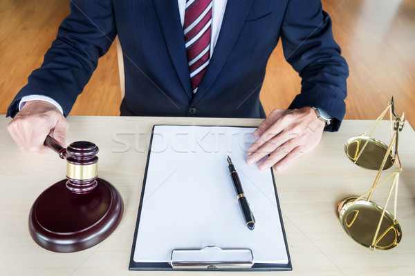 Male Judge In A Courtroom Striking The Gavel on sounding block Stock photo © snowing