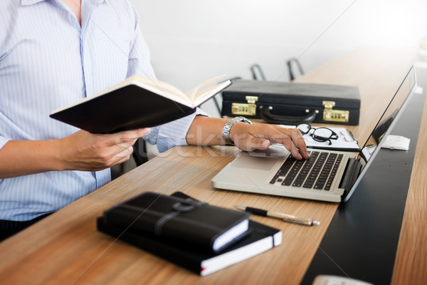 business men working on wooden desk(table) with notebook compute Stock photo © snowing
