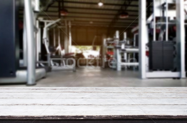 Wooden table on blurred background of fitness gym interior of mo Stock photo © snowing