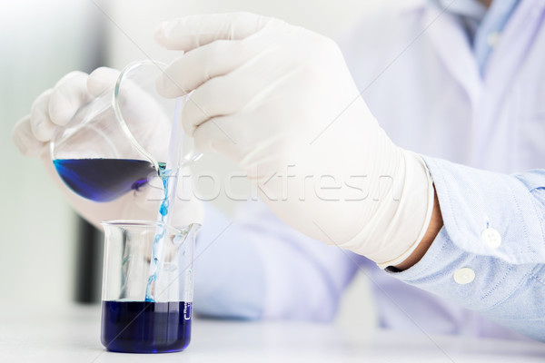 scientists and scientific equipment Pouring mixing reagents liqi Stock photo © snowing