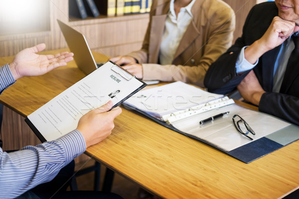 young man explaining about his profile to business managers sitt Stock photo © snowing