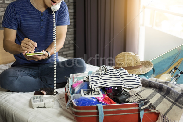 Young man hurring up to meeting and talking by phone and taking  Stock photo © snowing