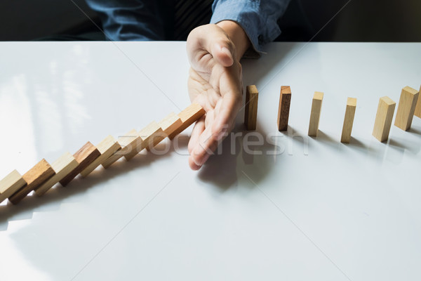 businessman hand stop dominoes continuous toppled or risk with c Stock photo © snowing