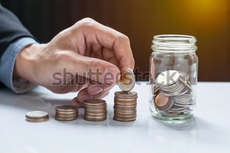 filling up coins to coin piles and glass for investment in the f Stock photo © snowing