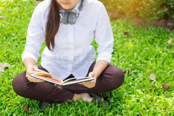 Pretty relaxed young beautiful woman reading a book in the garde Stock photo © snowing