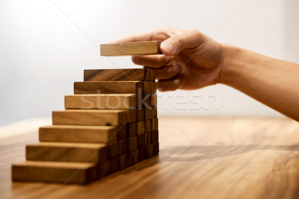 Business man hand put wooden blocks arranging stacking for devel Stock photo © snowing