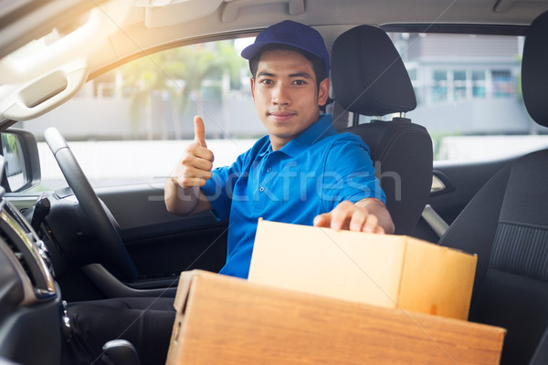 Delivery messenger man with cardboard box  outside the warehouse Stock photo © snowing