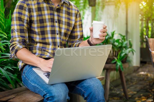 man on week-end working on laptop computer outdoor in a park gar Stock photo © snowing