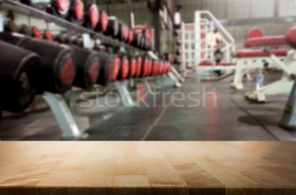 Wooden table on blurred background of fitness gym interior of mo Stock photo © snowing