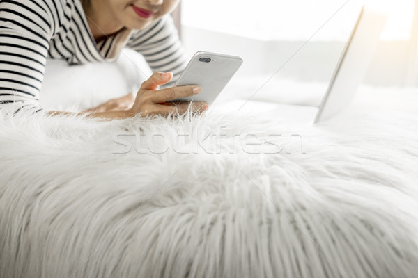 A beautiful caucasian woman lying down on the bed pretty girl us Stock photo © snowing