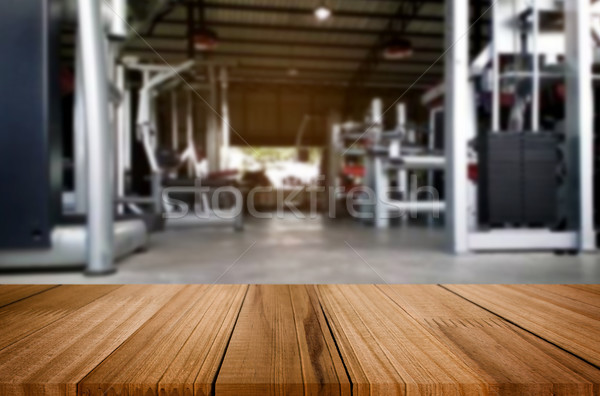 Wooden table on blurred background of fitness gym interior of mo Stock photo © snowing