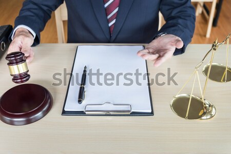 Male Judge In A Courtroom Striking The Gavel on sounding block Stock photo © snowing