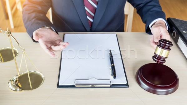 Stock photo: Male Judge In A Courtroom Striking The Gavel on sounding block