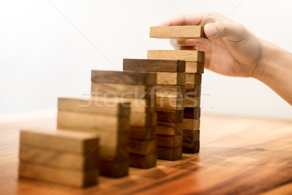 Business man hand put wooden blocks arranging stacking for devel Stock photo © snowing