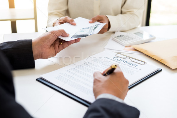 Corrupted businessman, or politician bribe in the form of hundre Stock photo © snowing