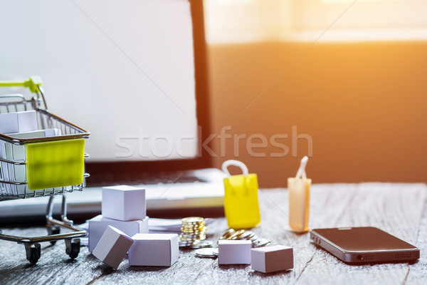 laptop blank screen and hopping cart full of gifts with copyspac Stock photo © snowing