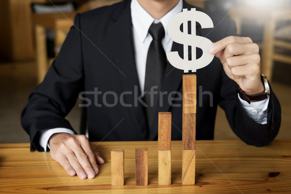 Concept growing value. hand of businessman pick up dollars symbo Stock photo © snowing