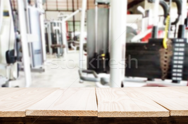 Wooden table on blurred background of fitness gym interior of mo Stock photo © snowing