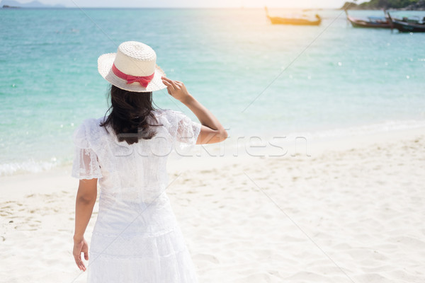 a beautiful carefree Woman relaxing at the beach enjoying her su Stock photo © snowing