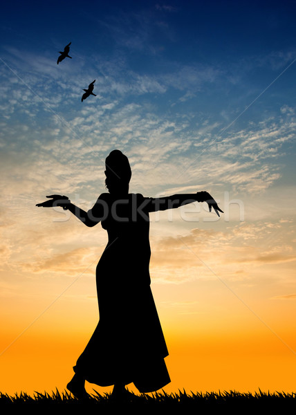 Woman dancing indian dance at sunset Stock photo © sognolucido