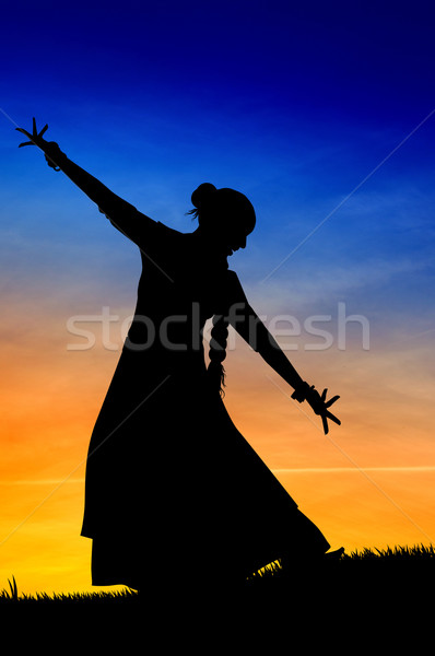 Woman dancing indian dance at sunset Stock photo © sognolucido