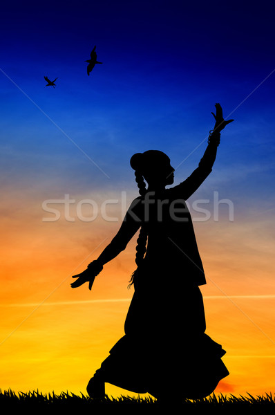 Woman dancing indian dance at sunset Stock photo © sognolucido