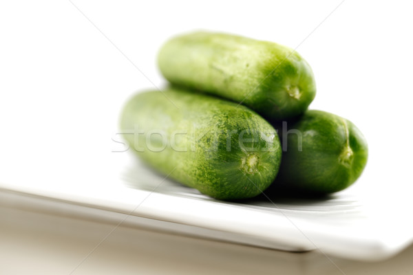 Organic cucumbers on a white ceramic plate Stock photo © SophieJames