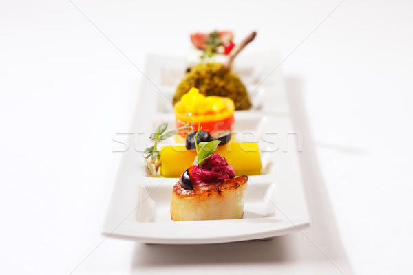Seared scallop, tuna wrap, smoked salmon and chicken drumstick Stock photo © SophieJames