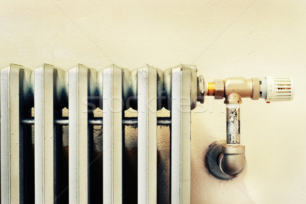 Closeup of an old radiator with a new thermostat Stock photo © soupstock