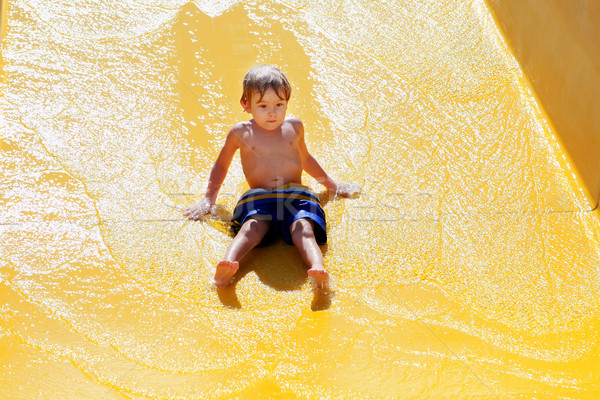 Young boy going down a waterslide Stock photo © soupstock