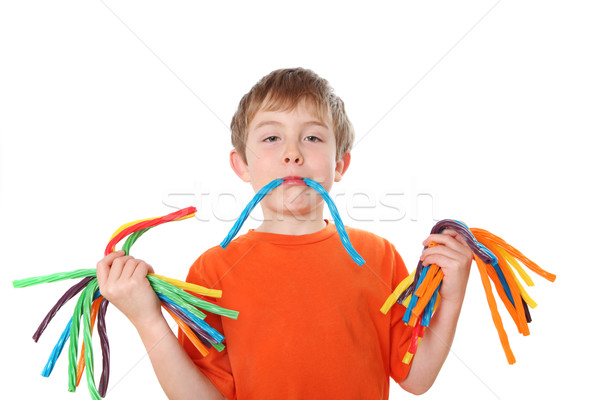 Junge halten farbenreich candy Hände Stock foto © soupstock